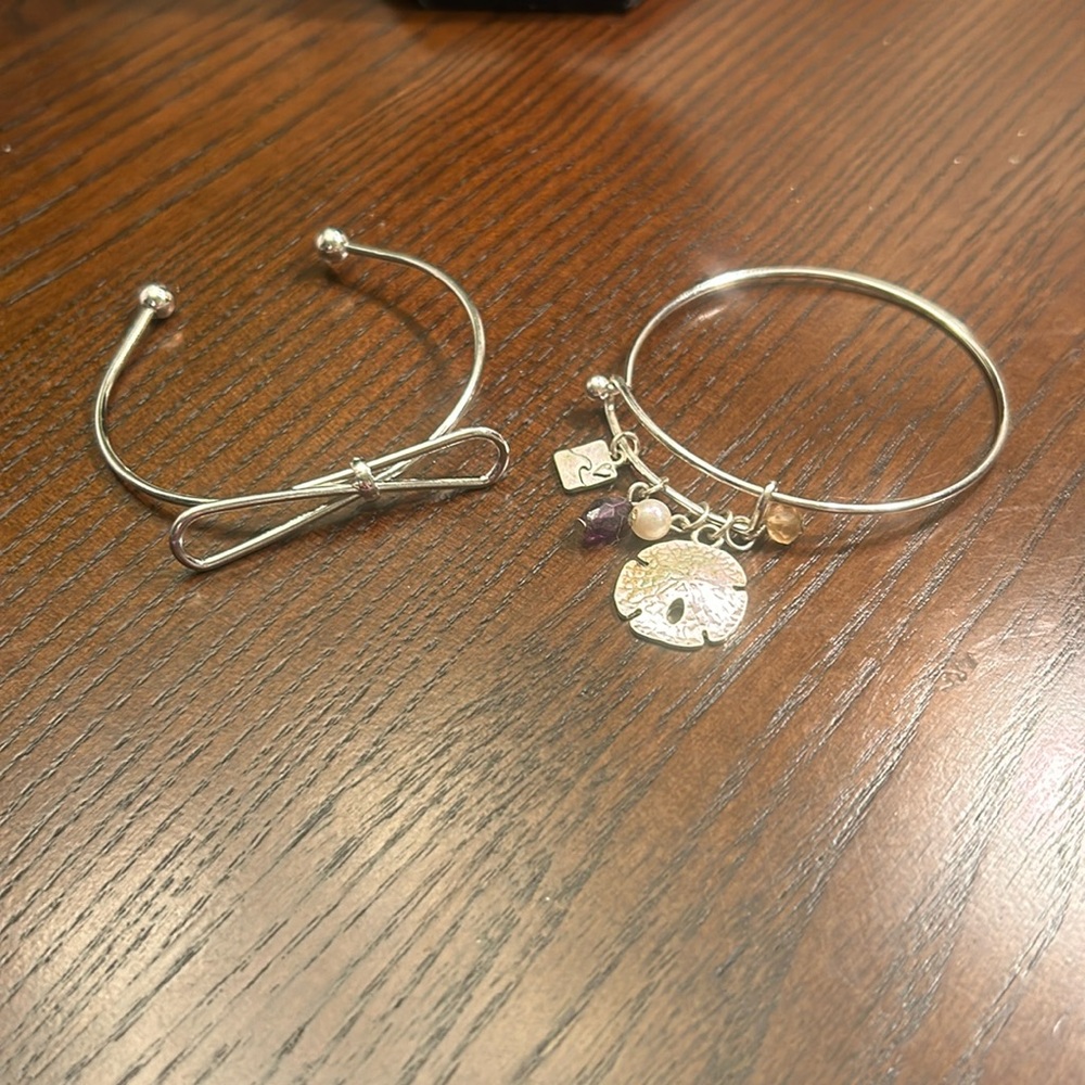 Silver-tone bracelets, 1 with bow and 1 with beach theme